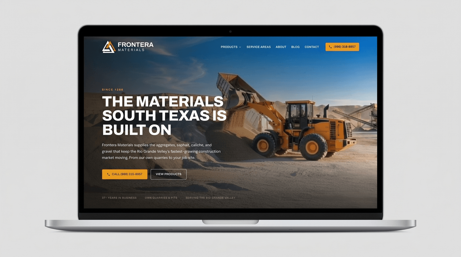 The new fmitex.com homepage shown on a laptop, with the "Materials" / "Service Areas" / "About" / "Blog" / "Contact" navigation, the "The materials South Texas is built on" hero, the "From our own quarries to your job site" subhead, a prominent phone-number button, and three product cards for Hot & Cold Mix Asphalt, Aggregates & Gravel, and Caliche.