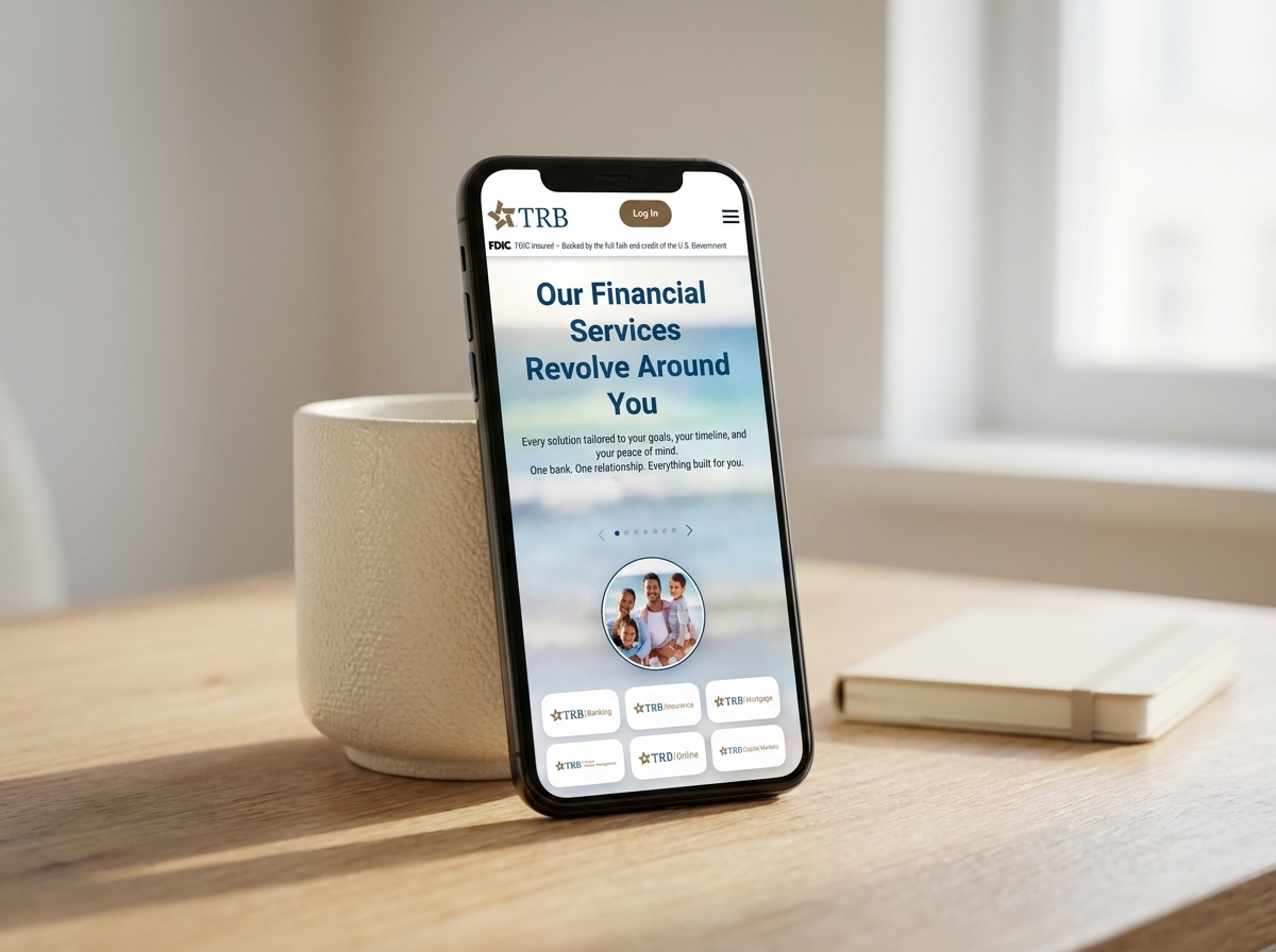 The trb.bank homepage on a mobile viewport, with the TRB logo and Log In button condensed into the top bar and the "Our Financial Services Revolve Around You" hero stacking cleanly above the sub-brand carousel.